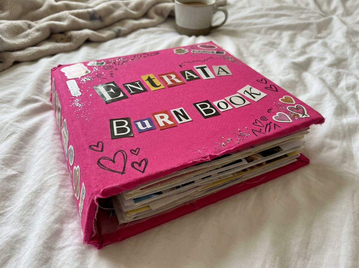 A hot pink burn book with cut-out magazine letters on the cover that read Entrata Burn Book